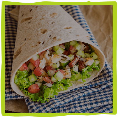 A wrapped burrito on a checked cloth